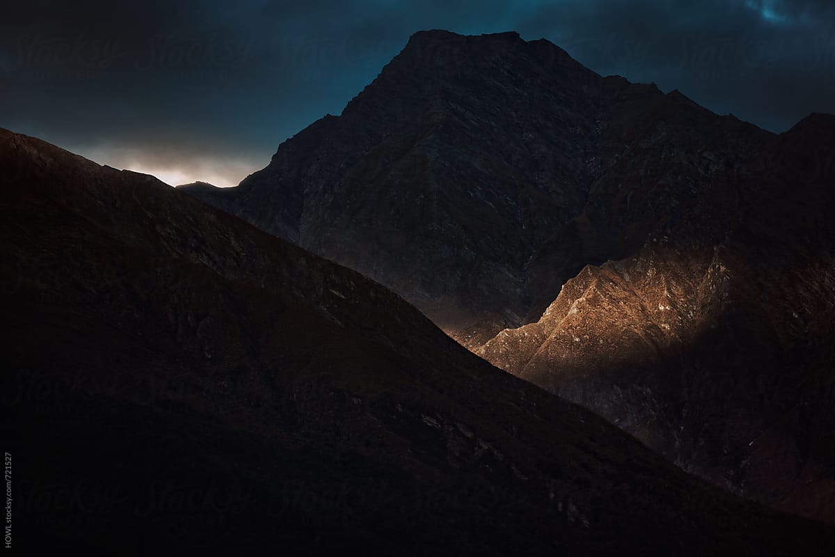 Morning light breaks on the rough peaks of a mountain