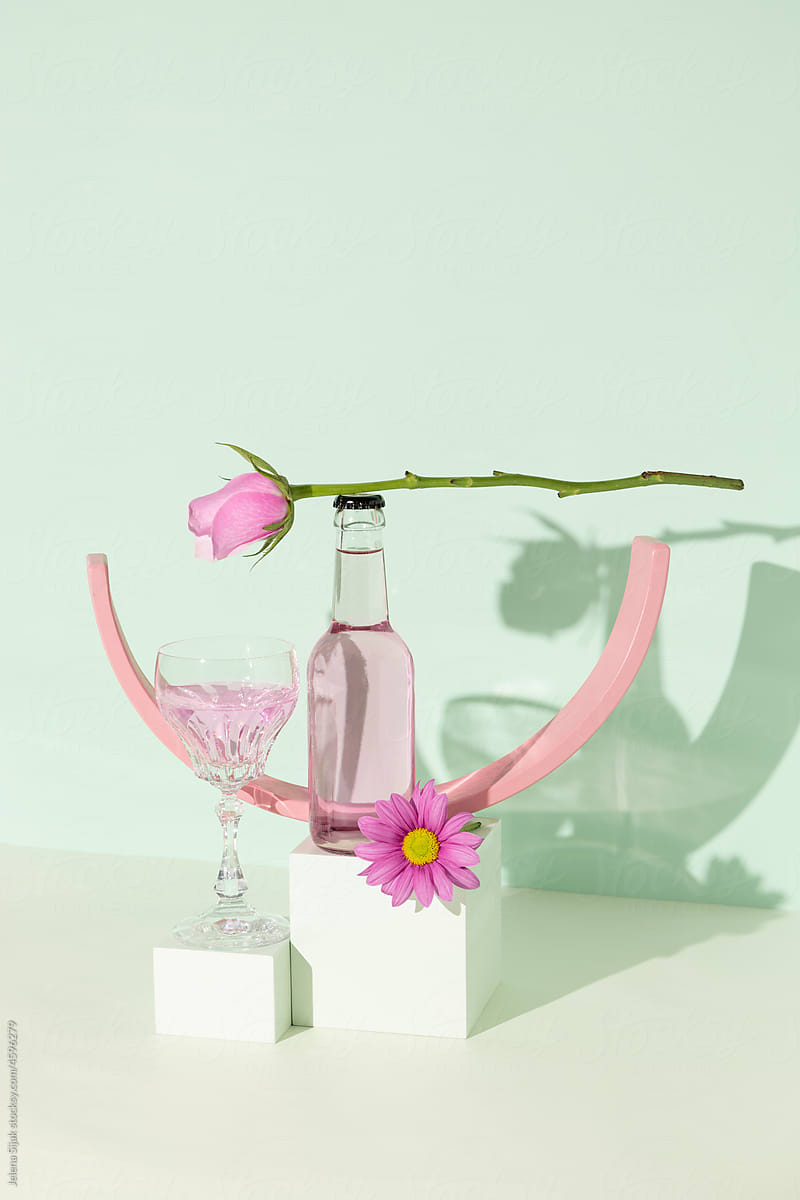 Gin and tonic cocktail With the pink rose and a flower on a mint