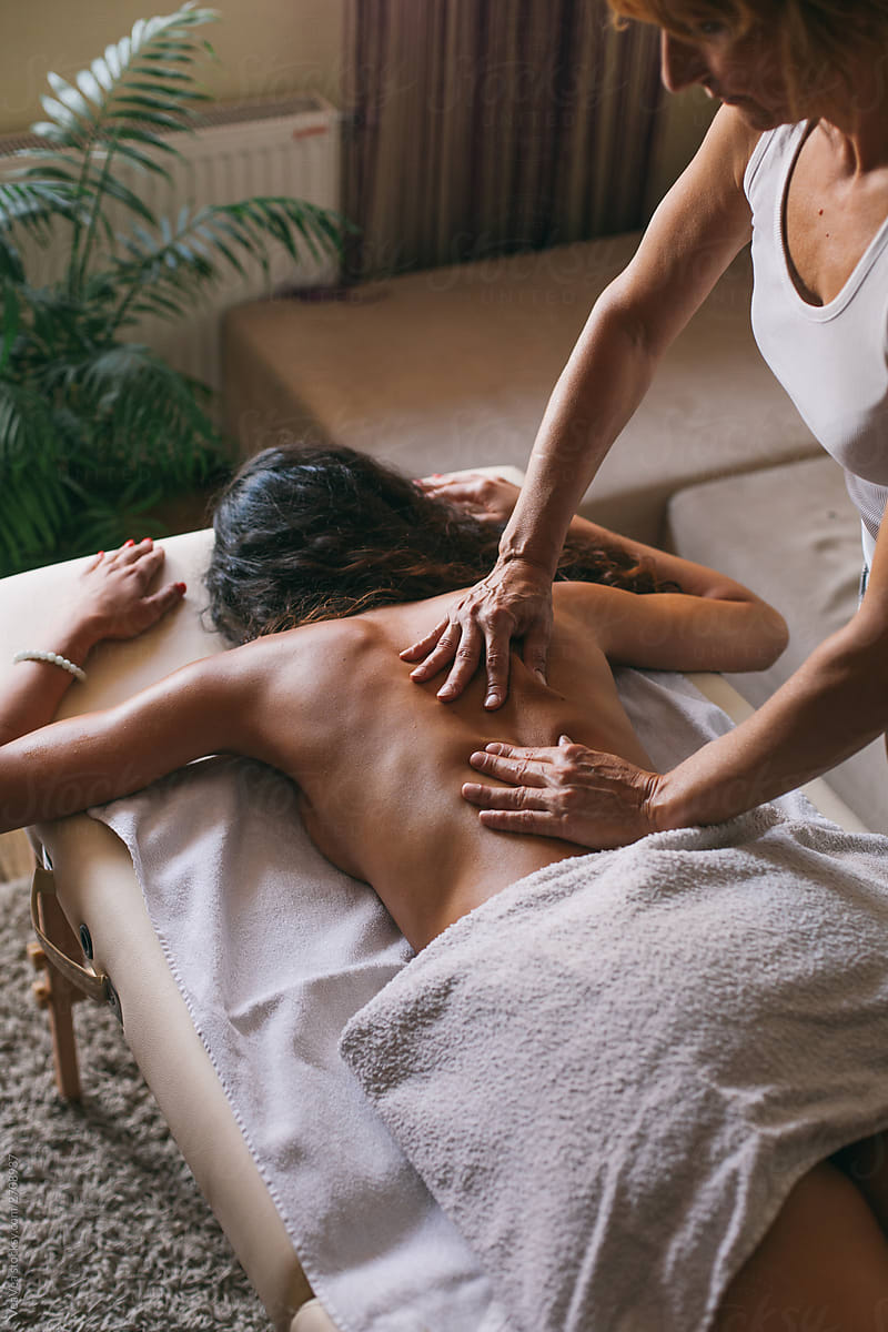 Masseur doing massage of female back
