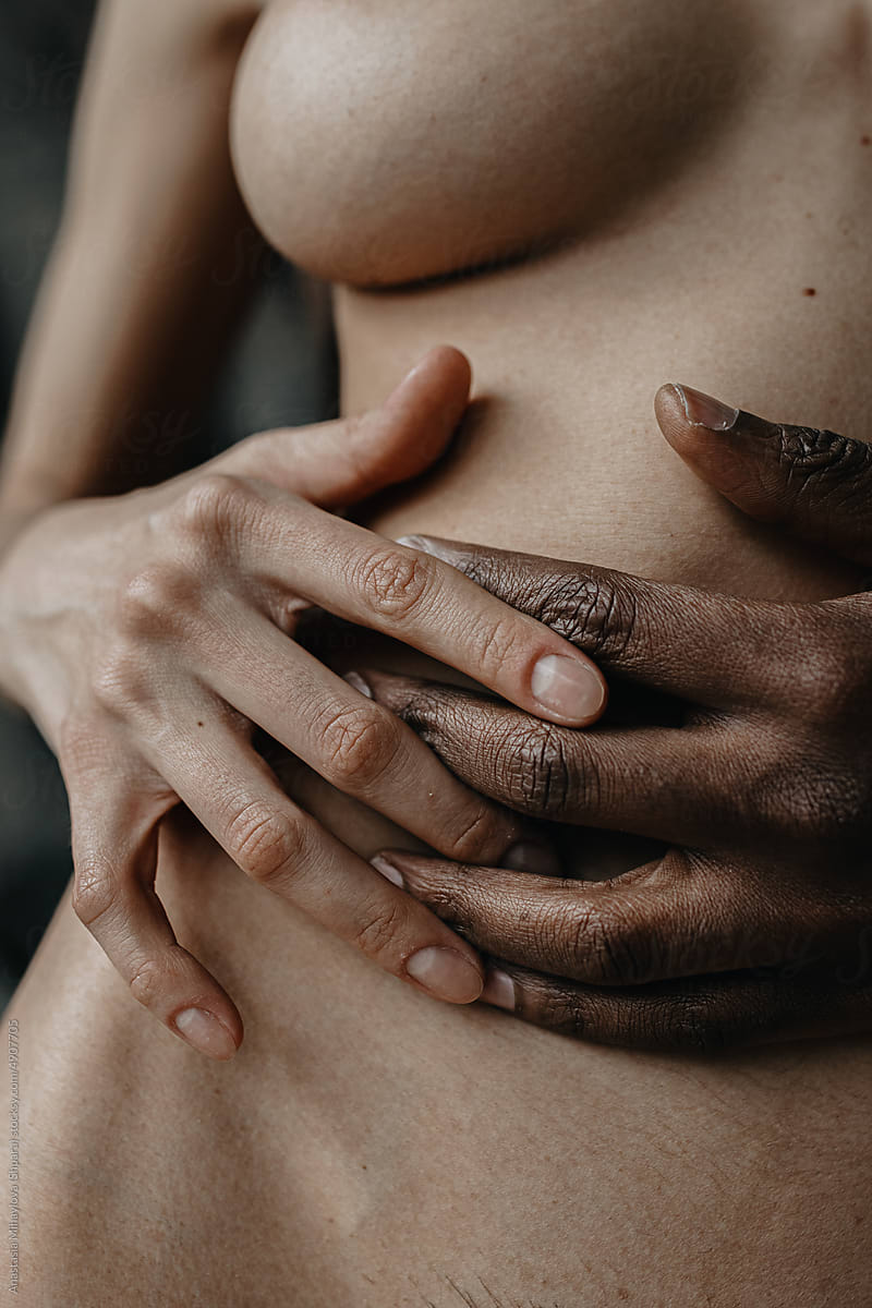 Close up photo of Multiethnic Love Couple With Clasped hands