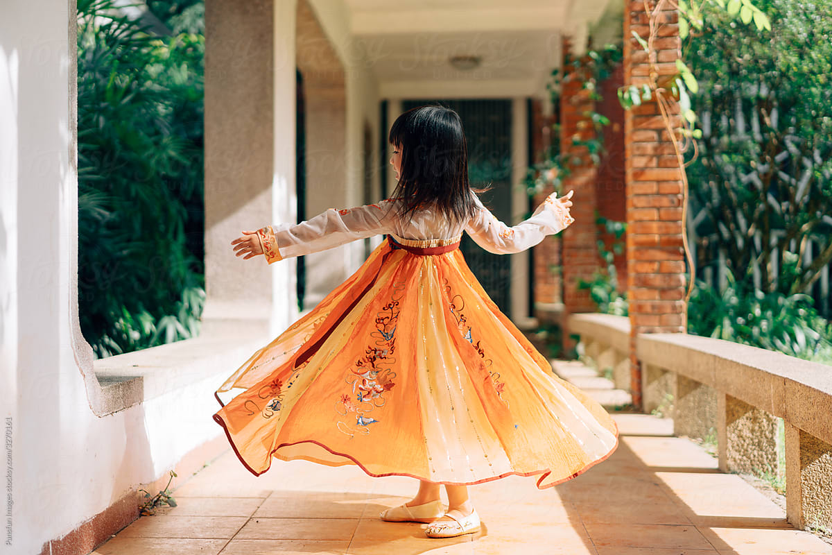 Chinese little girl play in traditional garden