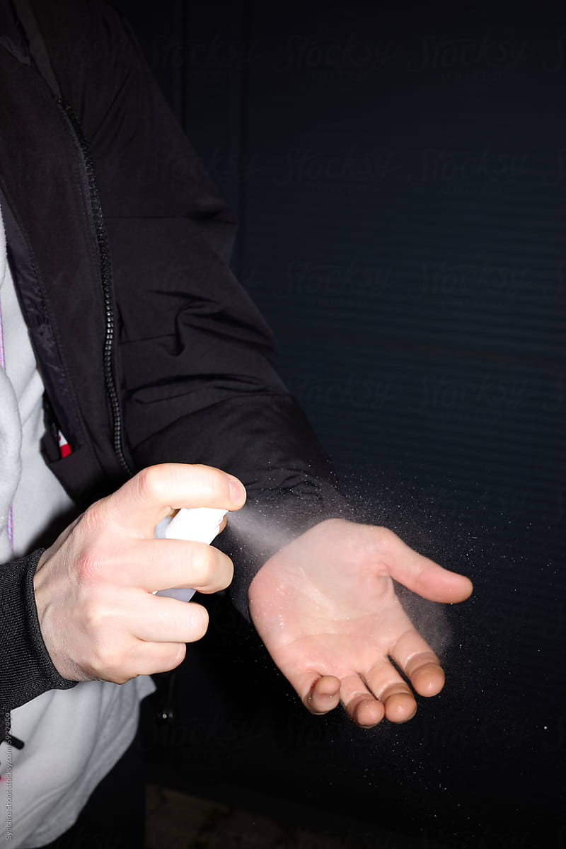 Hand sanitizing in dim light (close up shot)