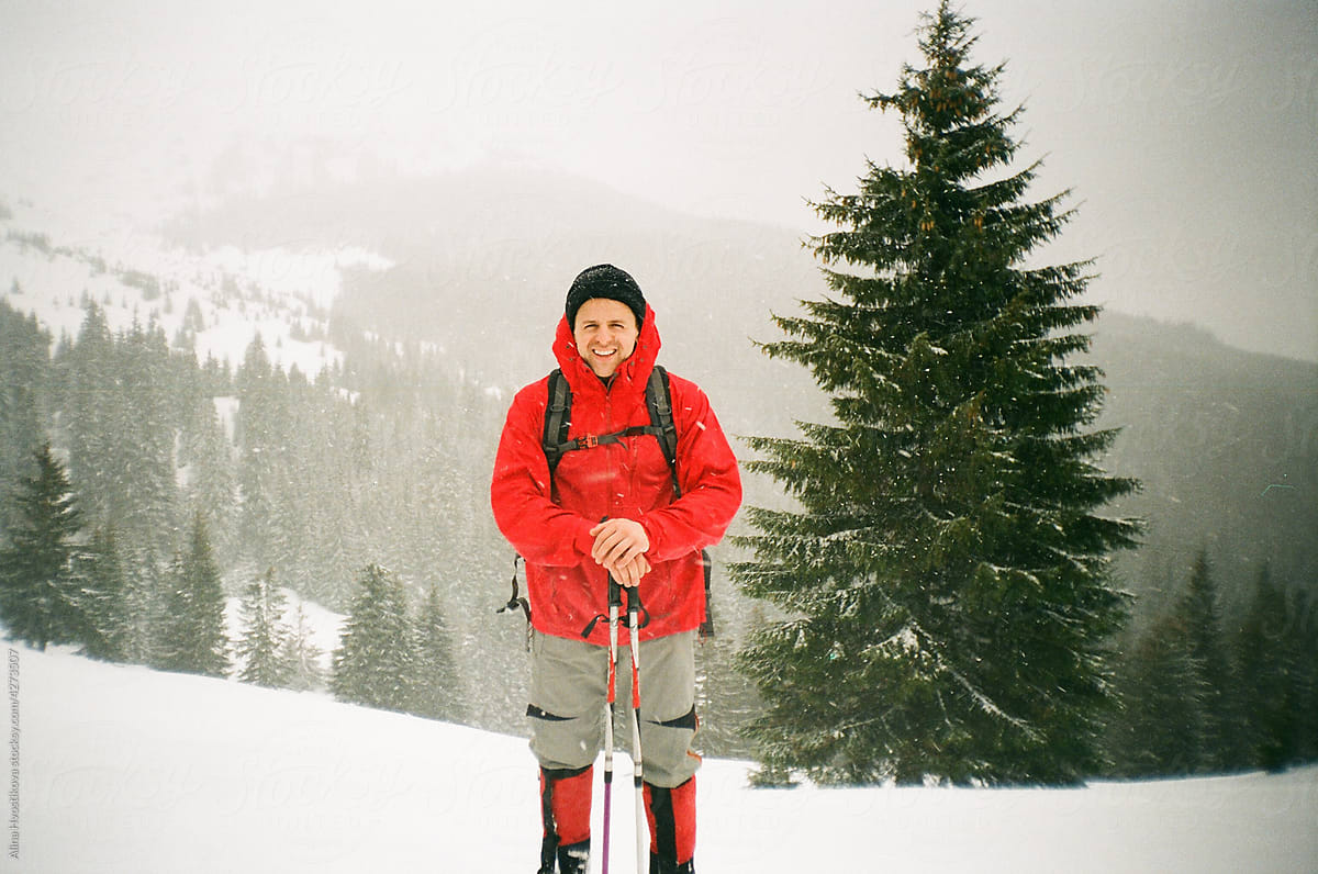 Delighted hiker in winter in mountains