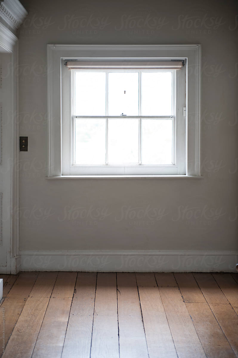 square window empty room interior wooden floorboards and grey wall by