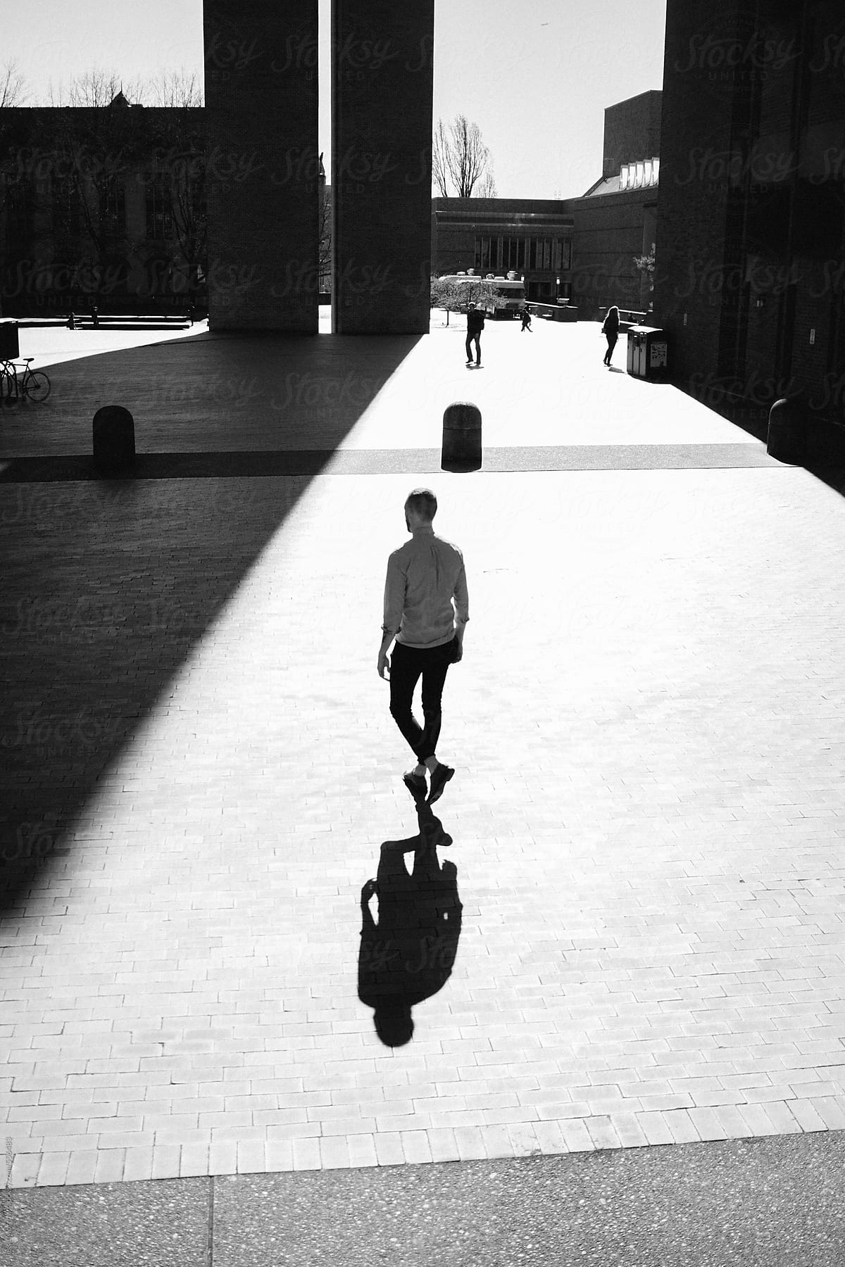 Black and white silhouette of student walking to class