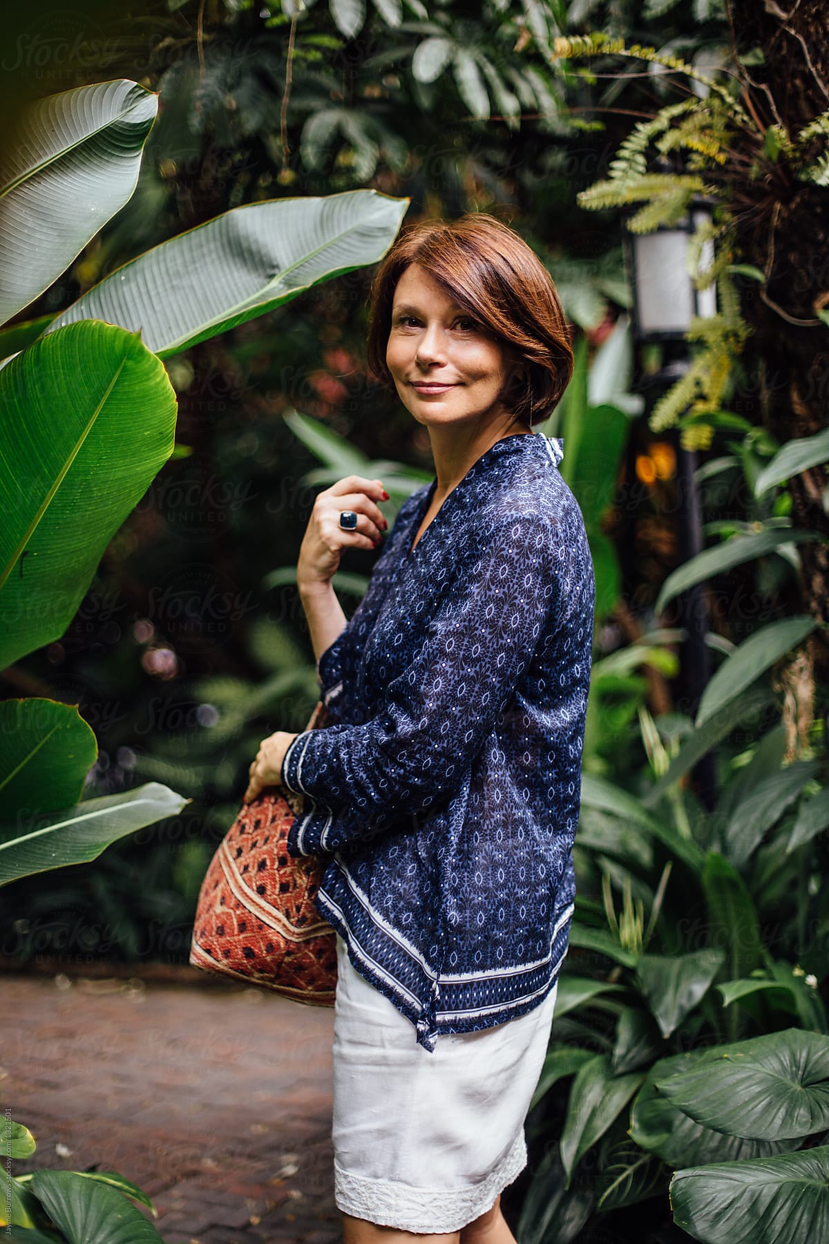 Portrait Of An Elegant Woman In A Tropical Setting By Stocksy