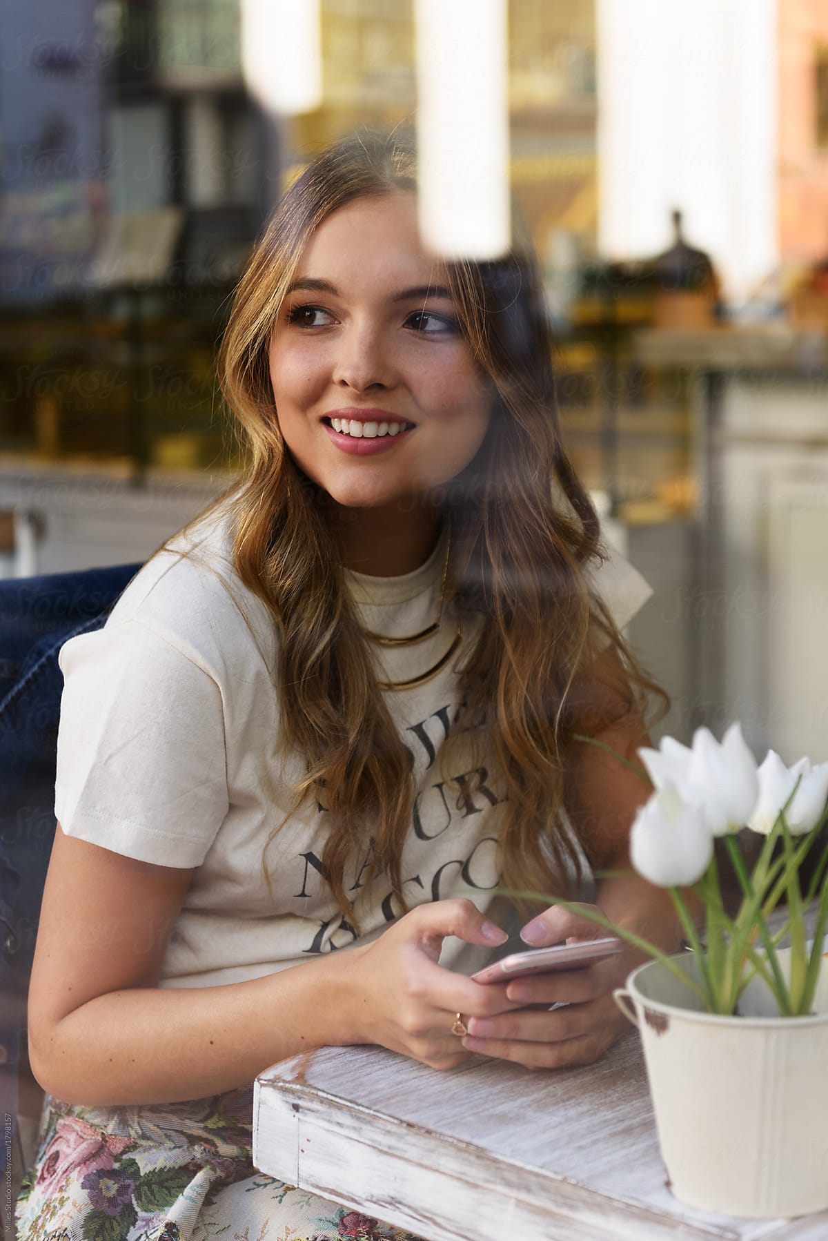  Charming Woman With Phone In Cafeteria By Stocksy Contributor Milles 