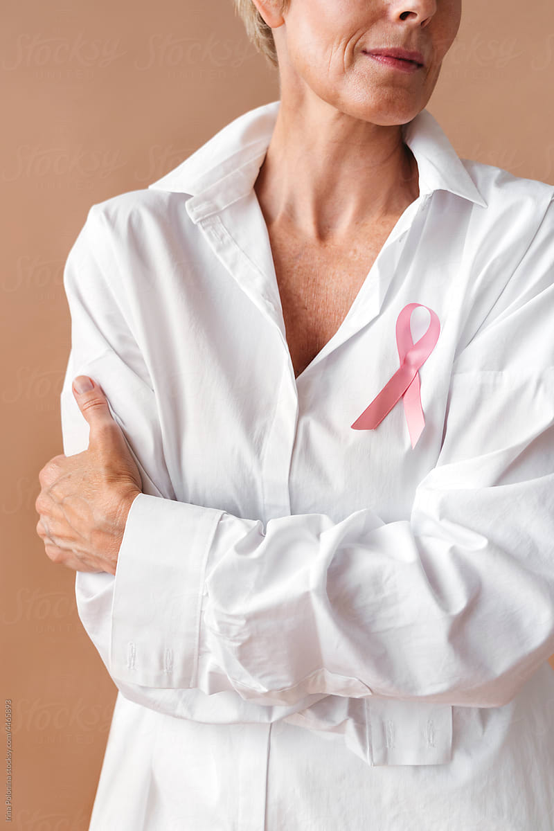 Crop portrait of woman with pink ribbon.