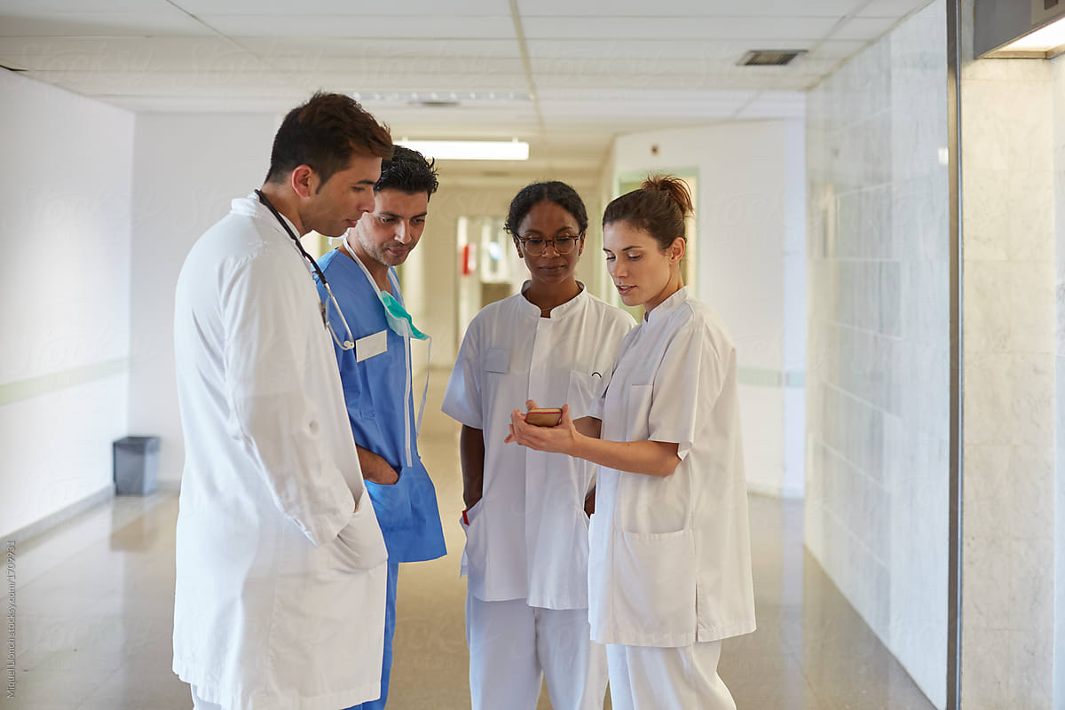 Group of medical staff talking in a relaxed moment in a hospital hall