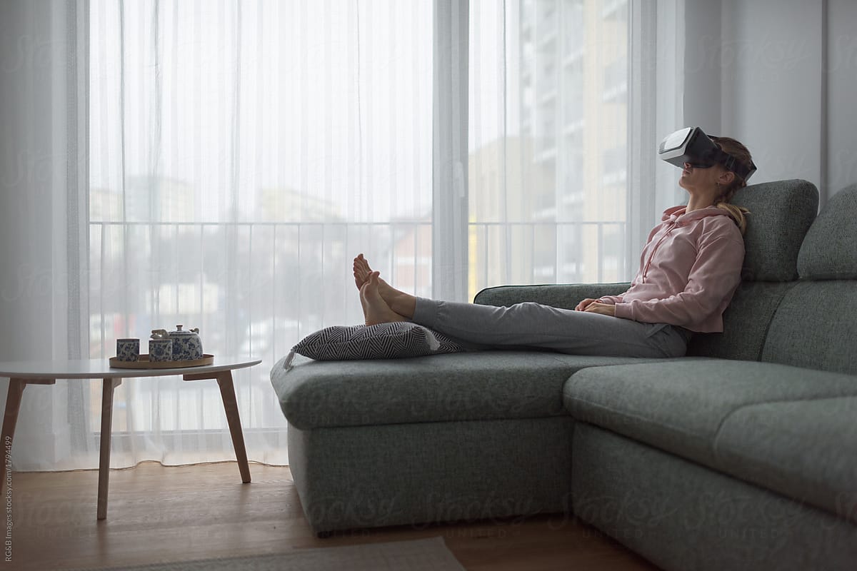 Woman with vr gear chilling out in the living room