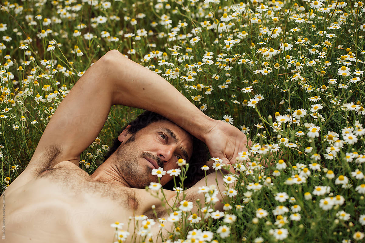 Man laying in a flowers bed