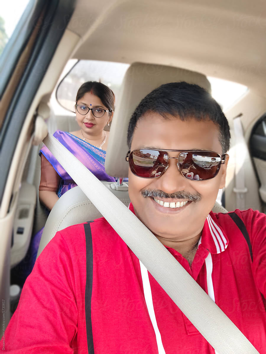 Indian couple travelling in a car
