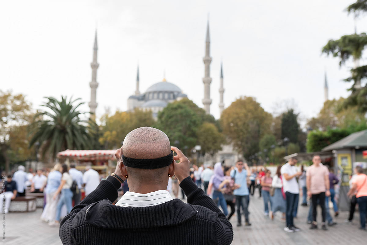 Man After Hair Transplantation Photographing Blue Mosque