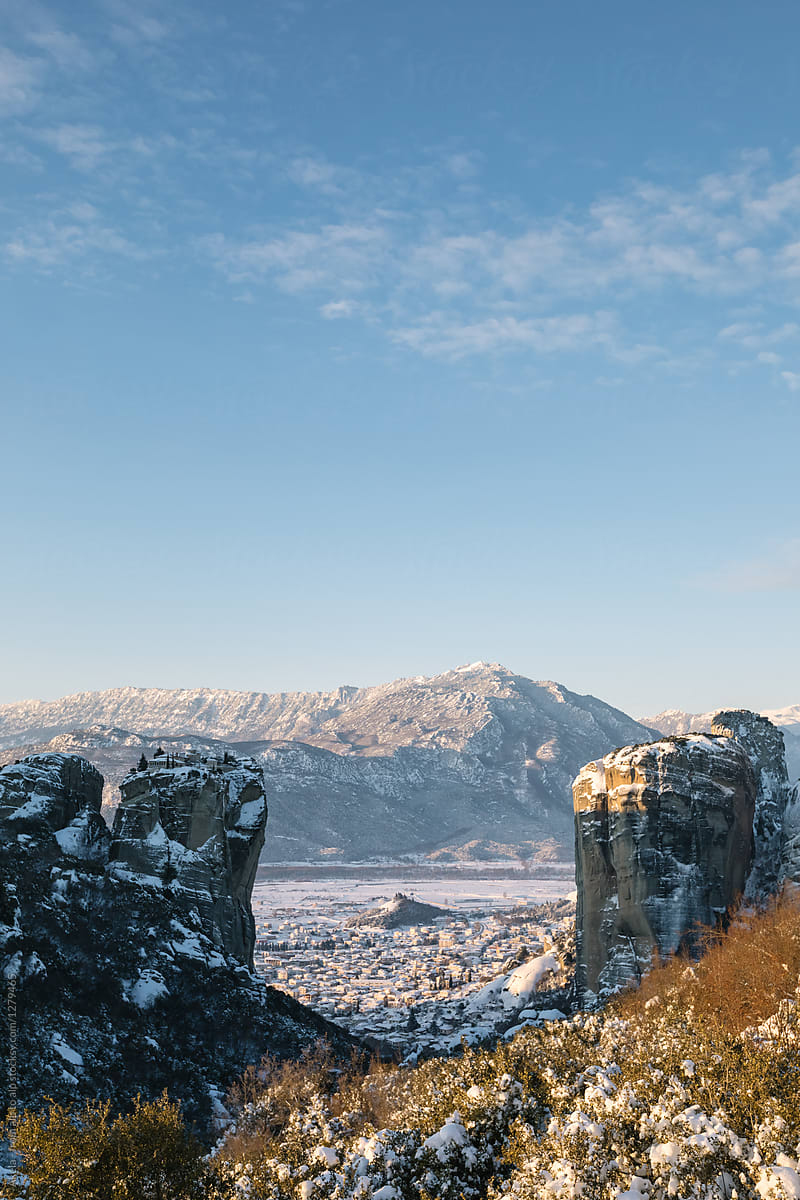 snowcovered meteora at sunrise with the city of kalambaka in the back