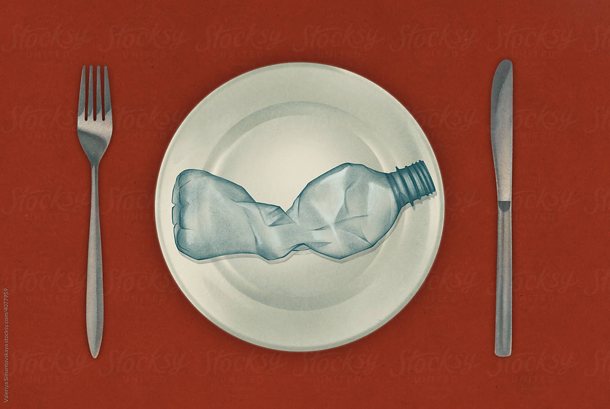 plastic bottle on a plate with a fork and a knife