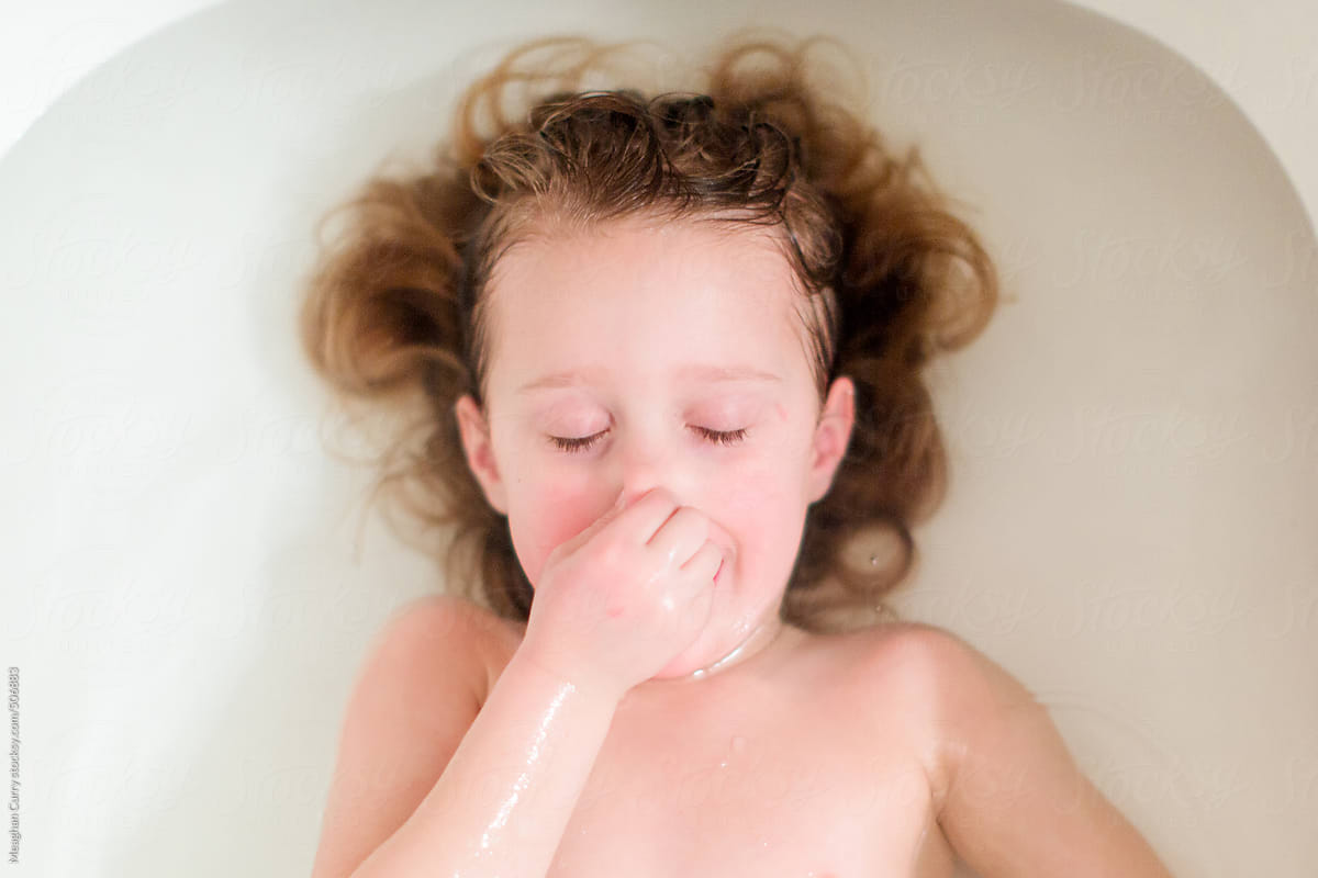 Little Girl Holding Her Nose And Partially Underwater In The