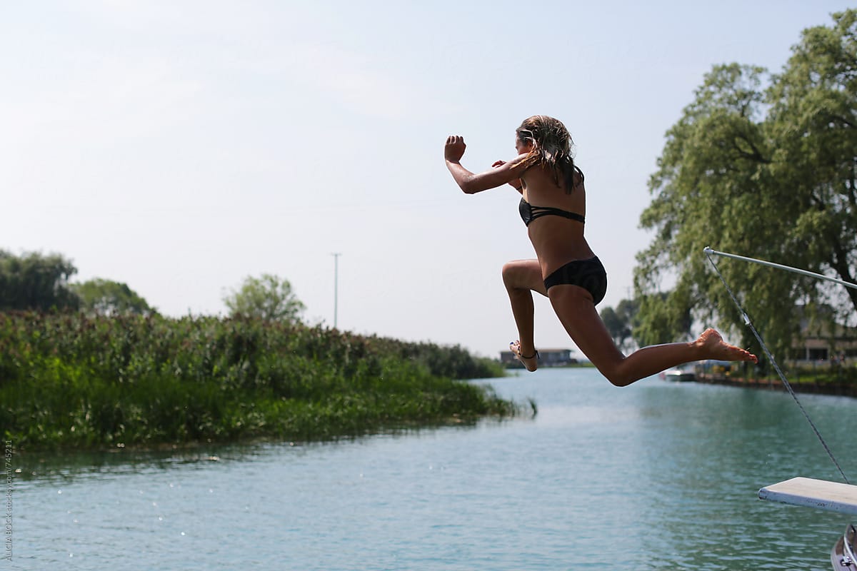 A Girl Jumping Off A Diving Board
