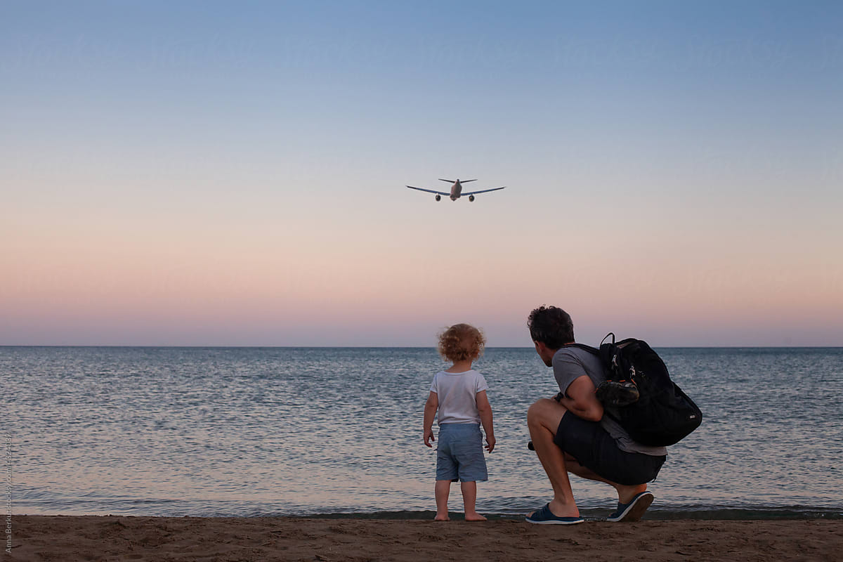 wanderlust travel, father and child looking at airplane
