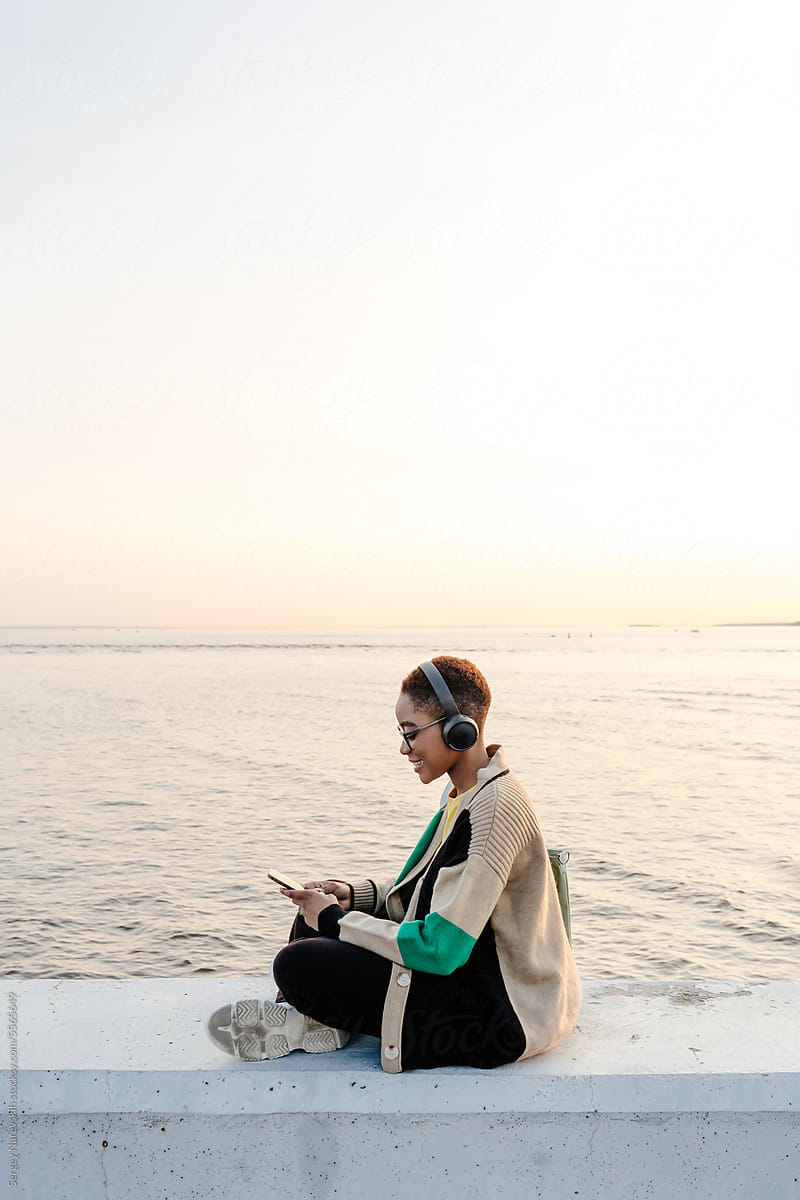 Woman with headphones using smartphone