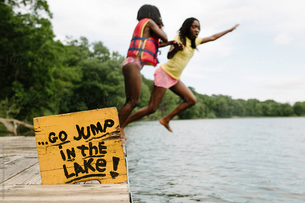 Two Black Girls Jumping in Lake
