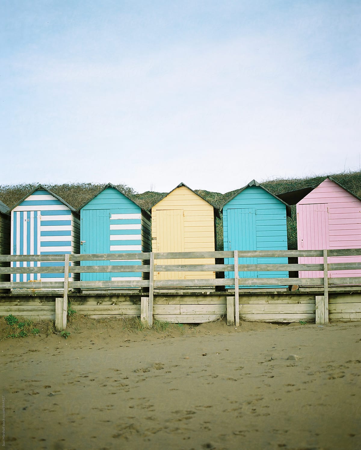 colourful painted beach huts