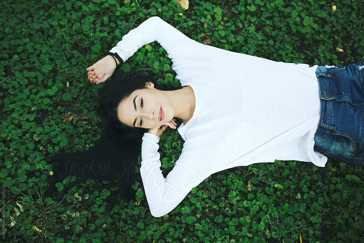 Beautiful Young Woman Lying On Grass And Smiling By Stocksy Contributor Jovana Rikalo Stocksy