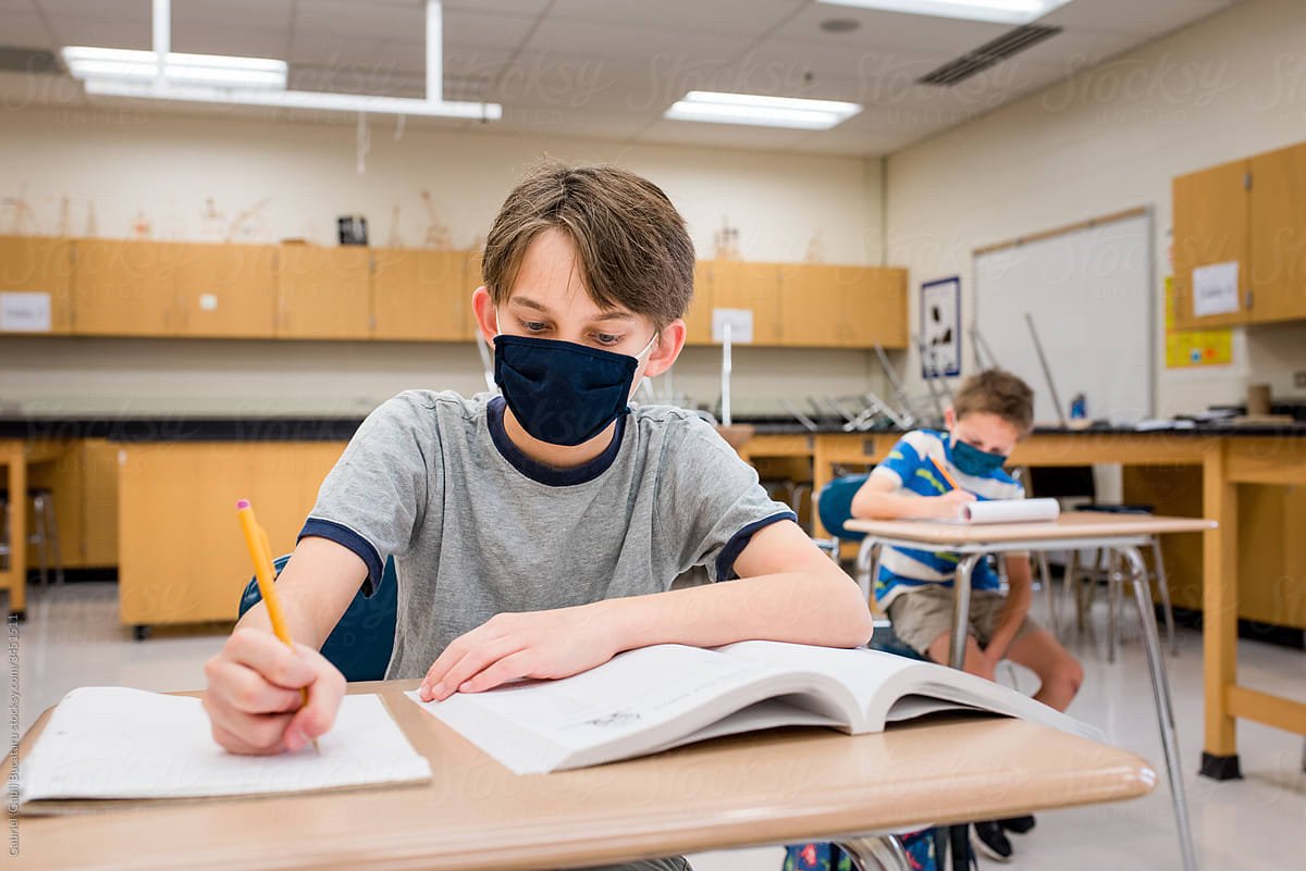 Boy with mask in a classroom during covid-19
