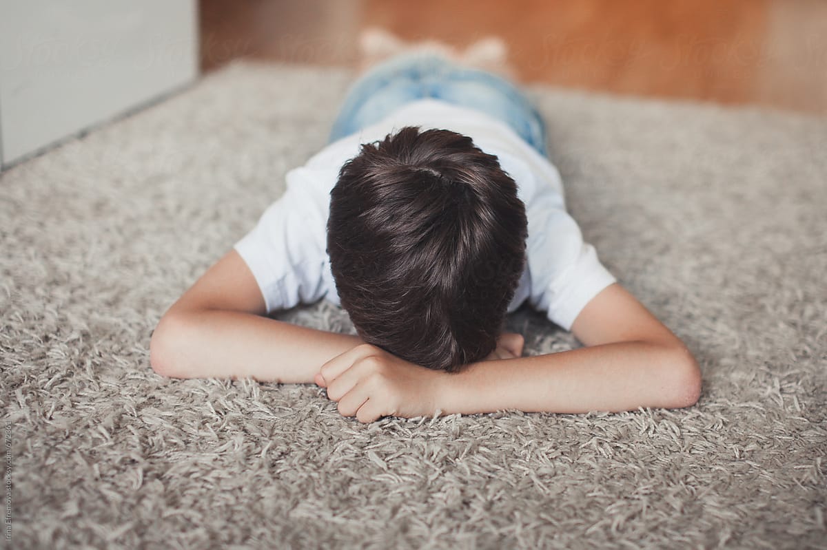 Young Boy Laying Upset On The Floor By Irina Efremova Stocksy United