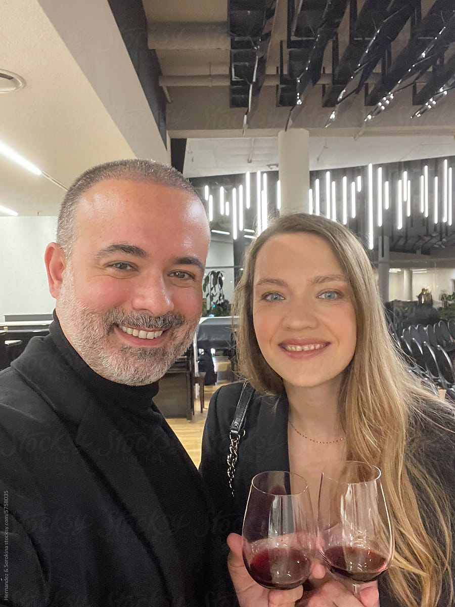 Selfie Of Couple Holding Red Wine In Concert Hall