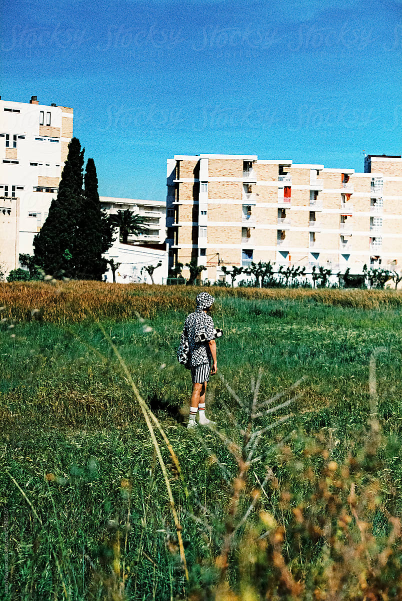 man walking next to an apartment complex, 35mm