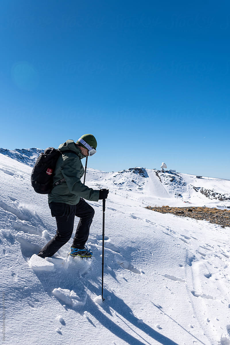 Hiker in crampons in highlands in winter