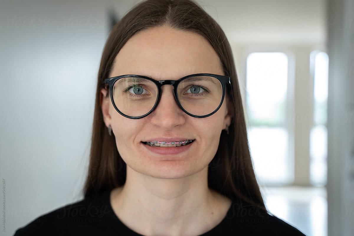 Young Woman Smiling with Braces and Glasses. Self-confident female