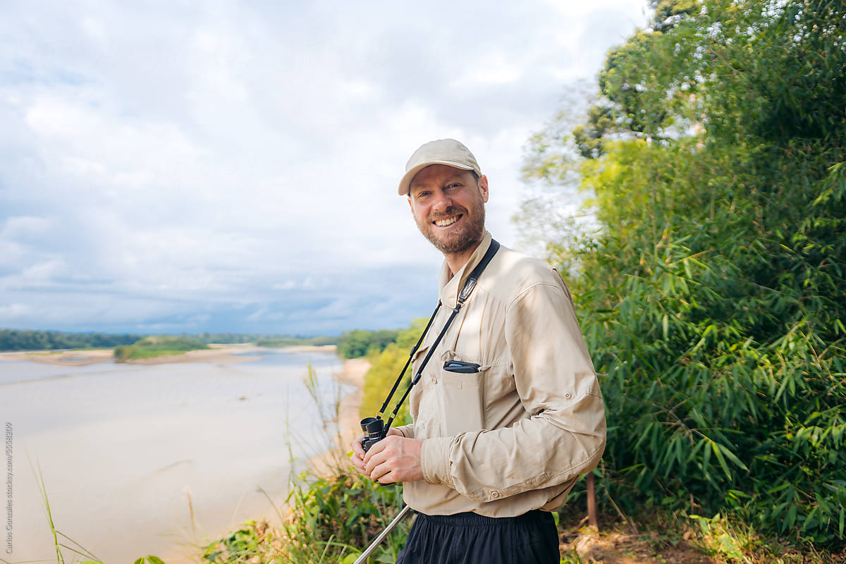 Man with binoculars in the jungle