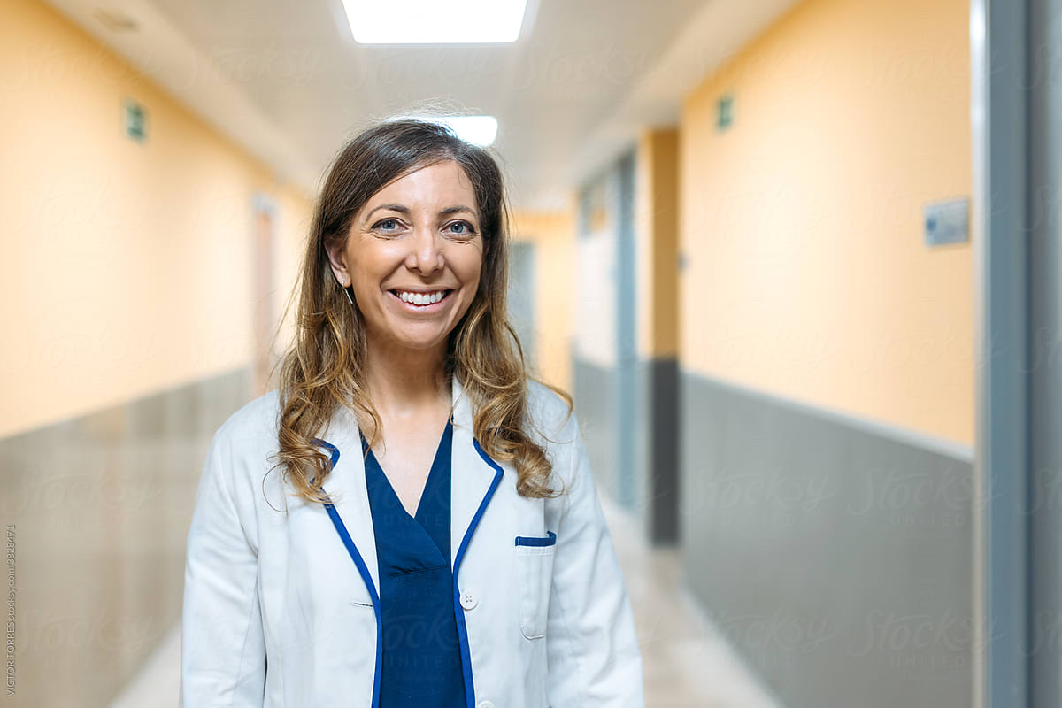 Happy confident doctor in a hospital corridor