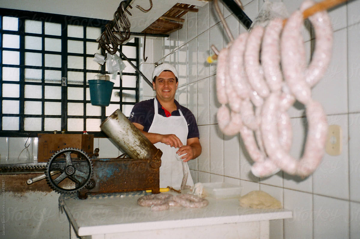 Butcher stuffing sausages artisanally: handmade process
