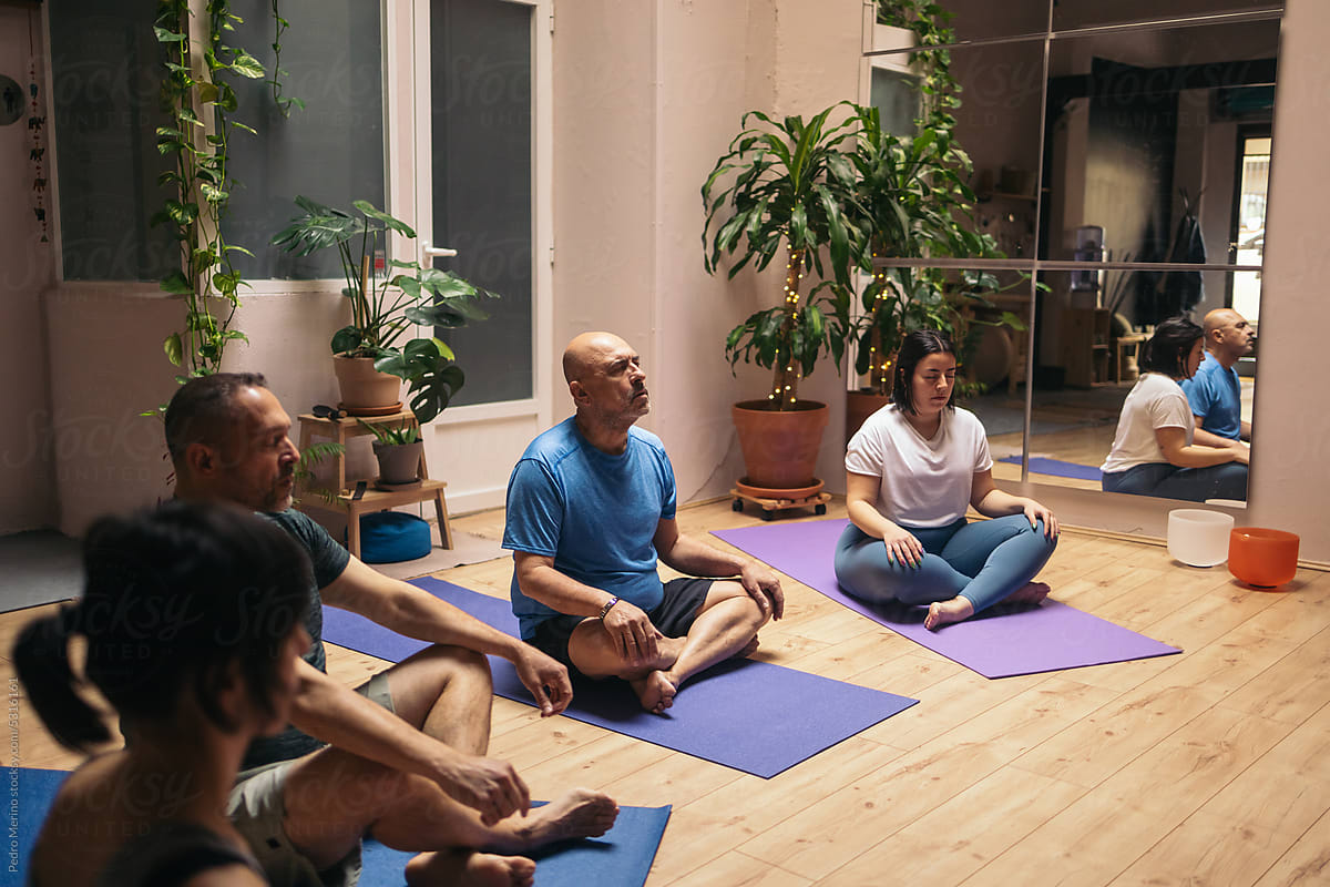Group of people receiving a yoga class