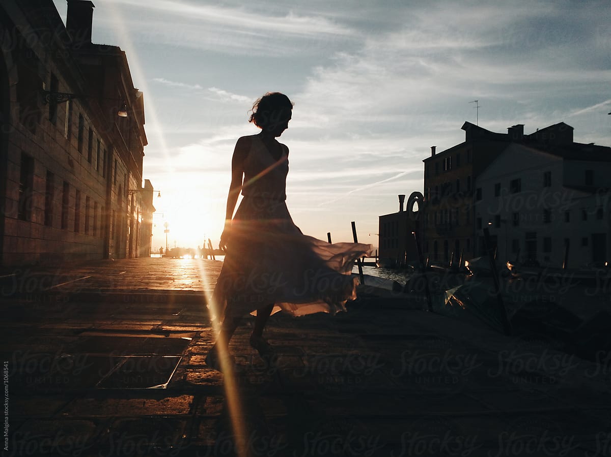 A woman dancing on sunset in venice