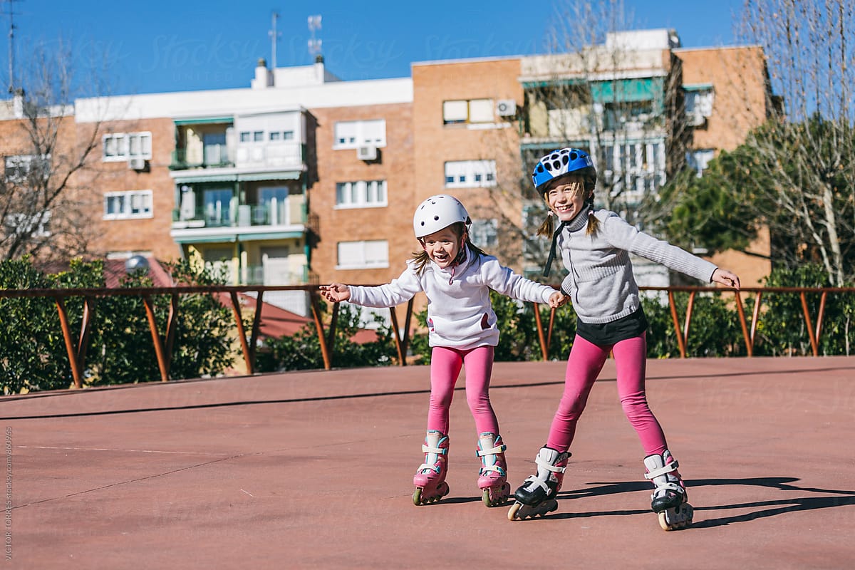 Two Sisters Roller Skating in an Outdoor Rink