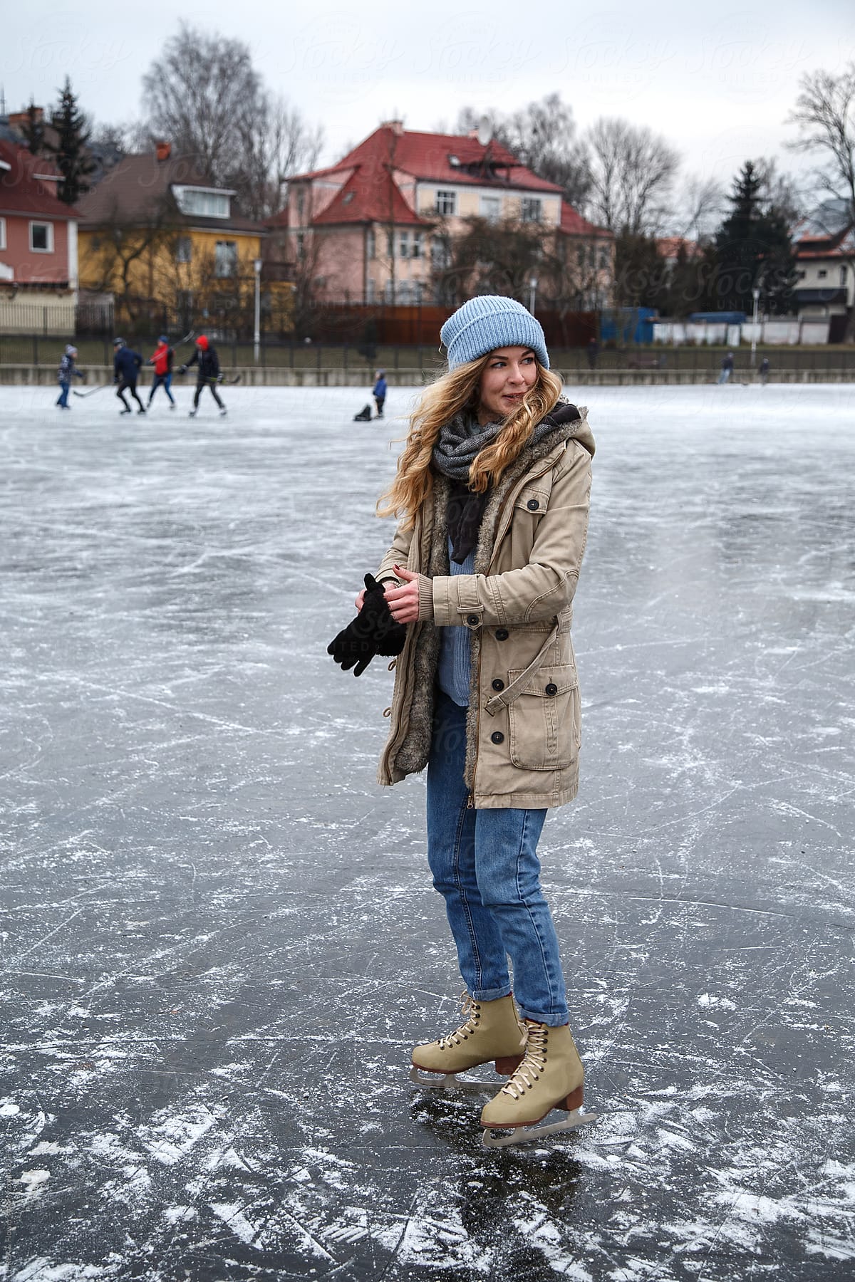 Woman putting on gloves on rink
