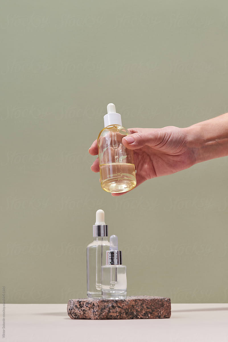 Crop of woman hand with bottle of essential oil