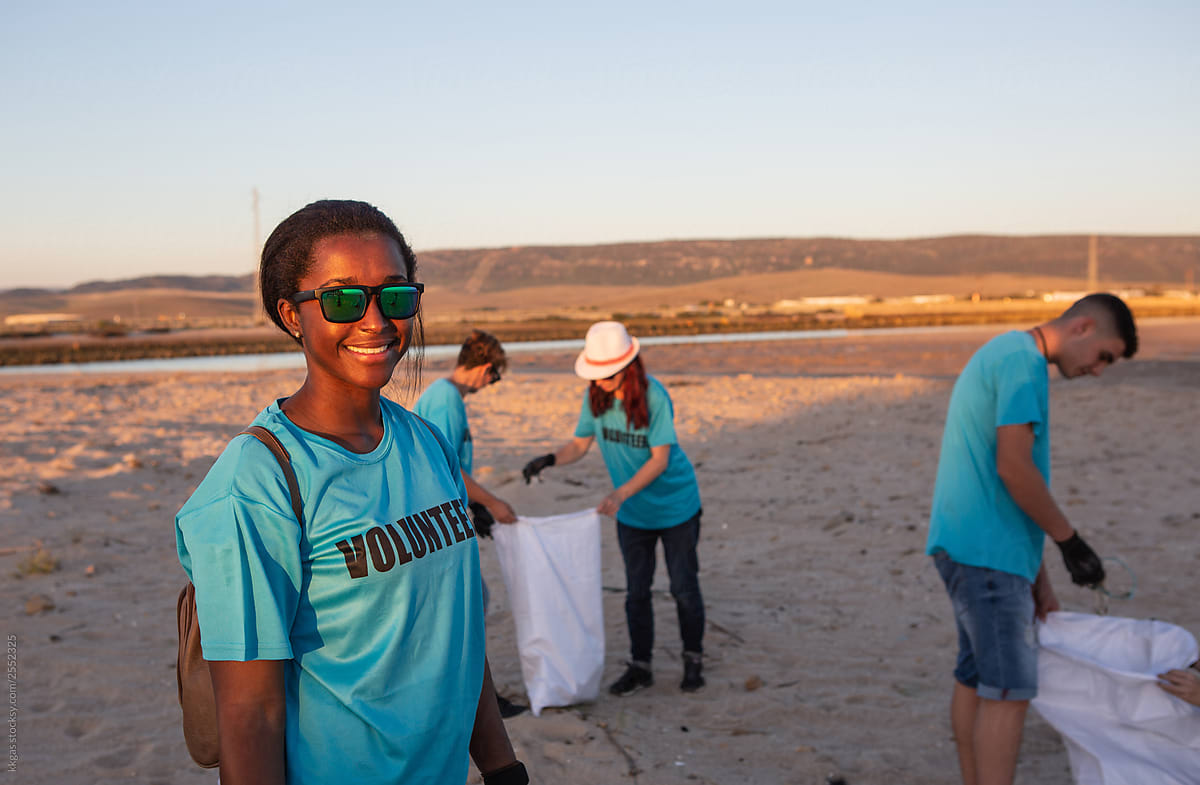 Woman smiling during community  beach clean