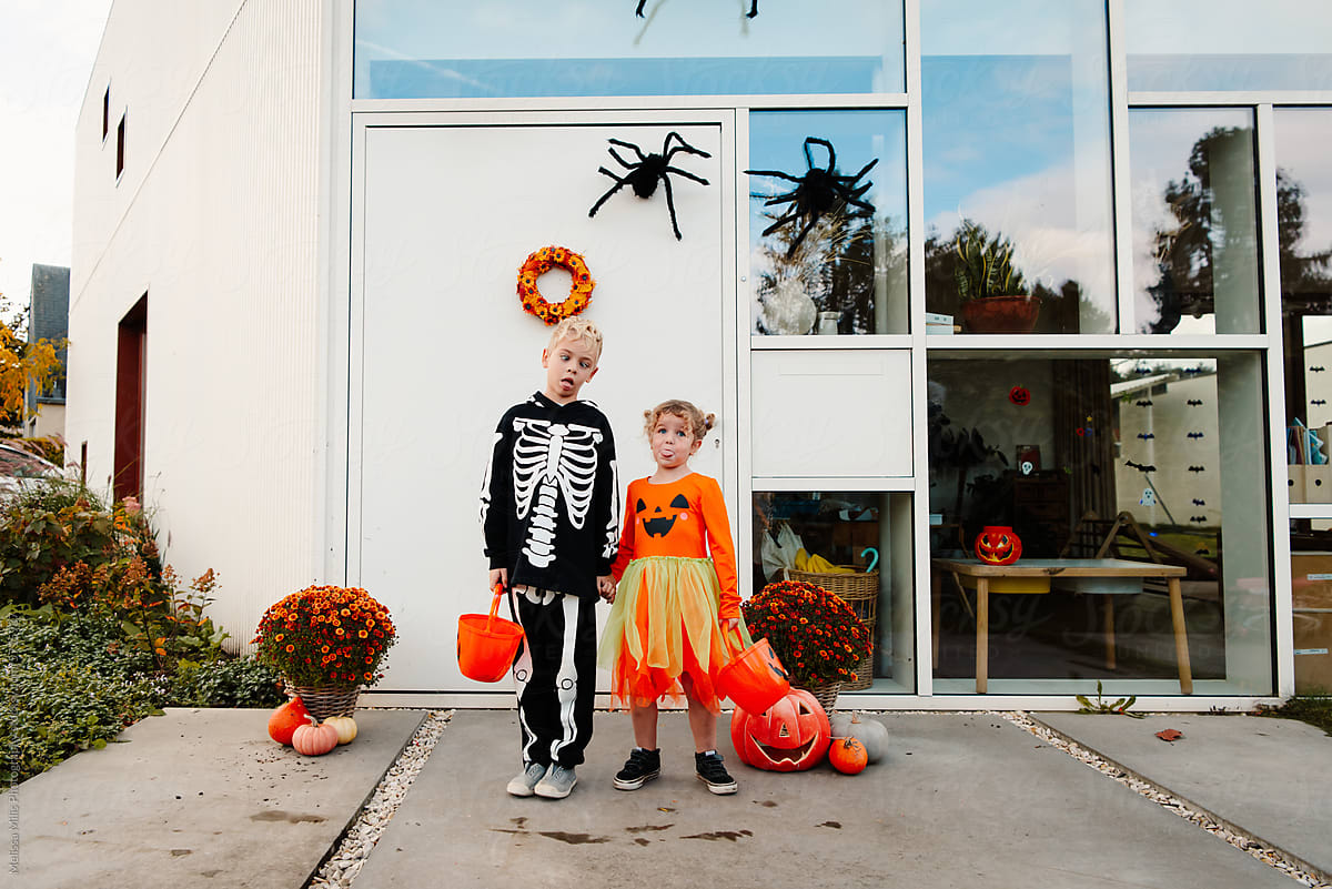Two Halloween Kids in front of door