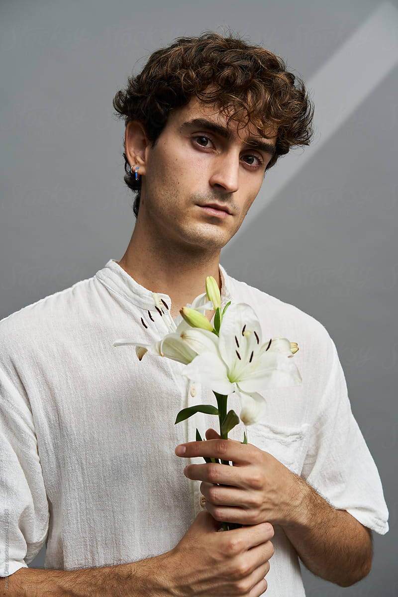 Man with lily flower in studio