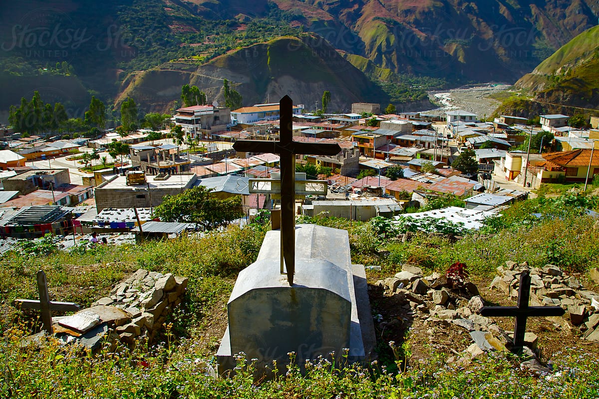 Three graves with crosses on a hillside cemetery in the mountain community of Saint Teresa, Peru