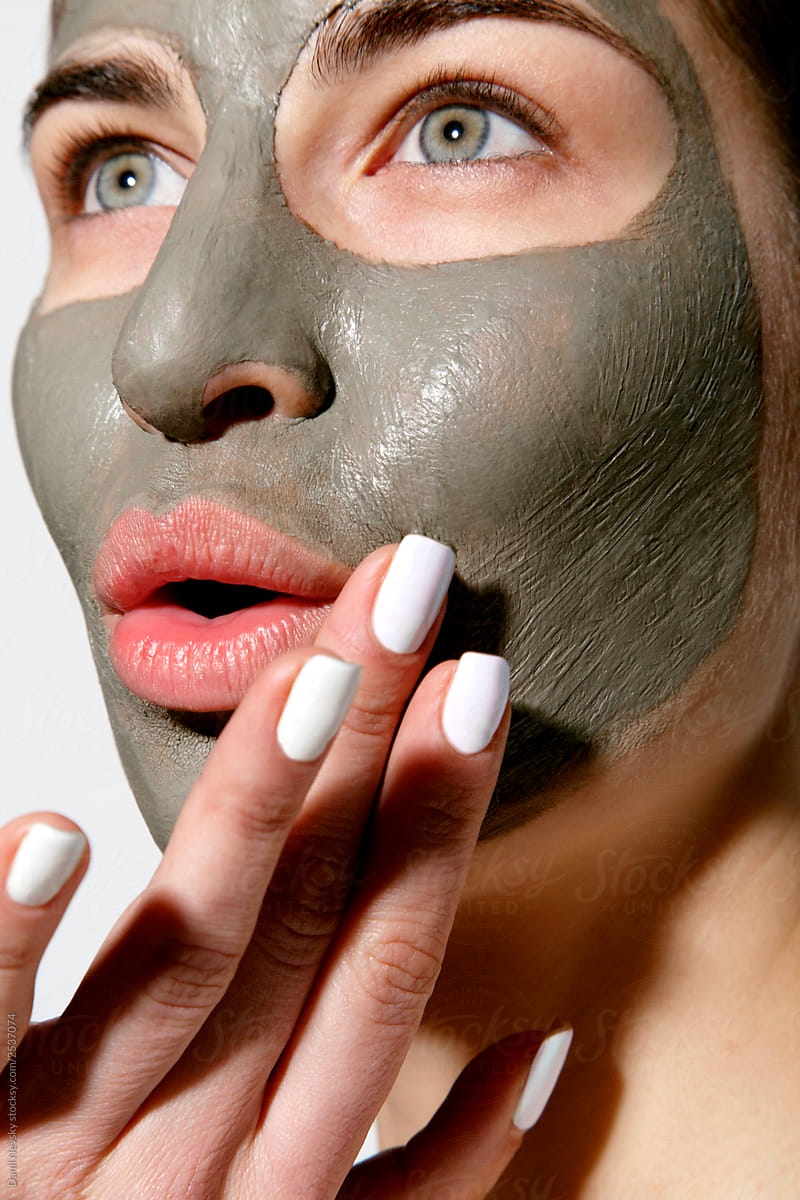 Young female with cosmetic clay mask