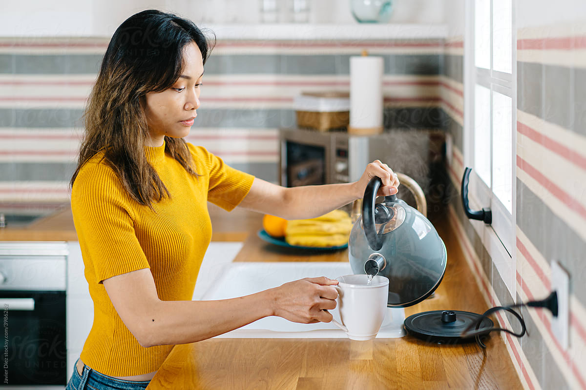 Asian woman preparing tea in morning