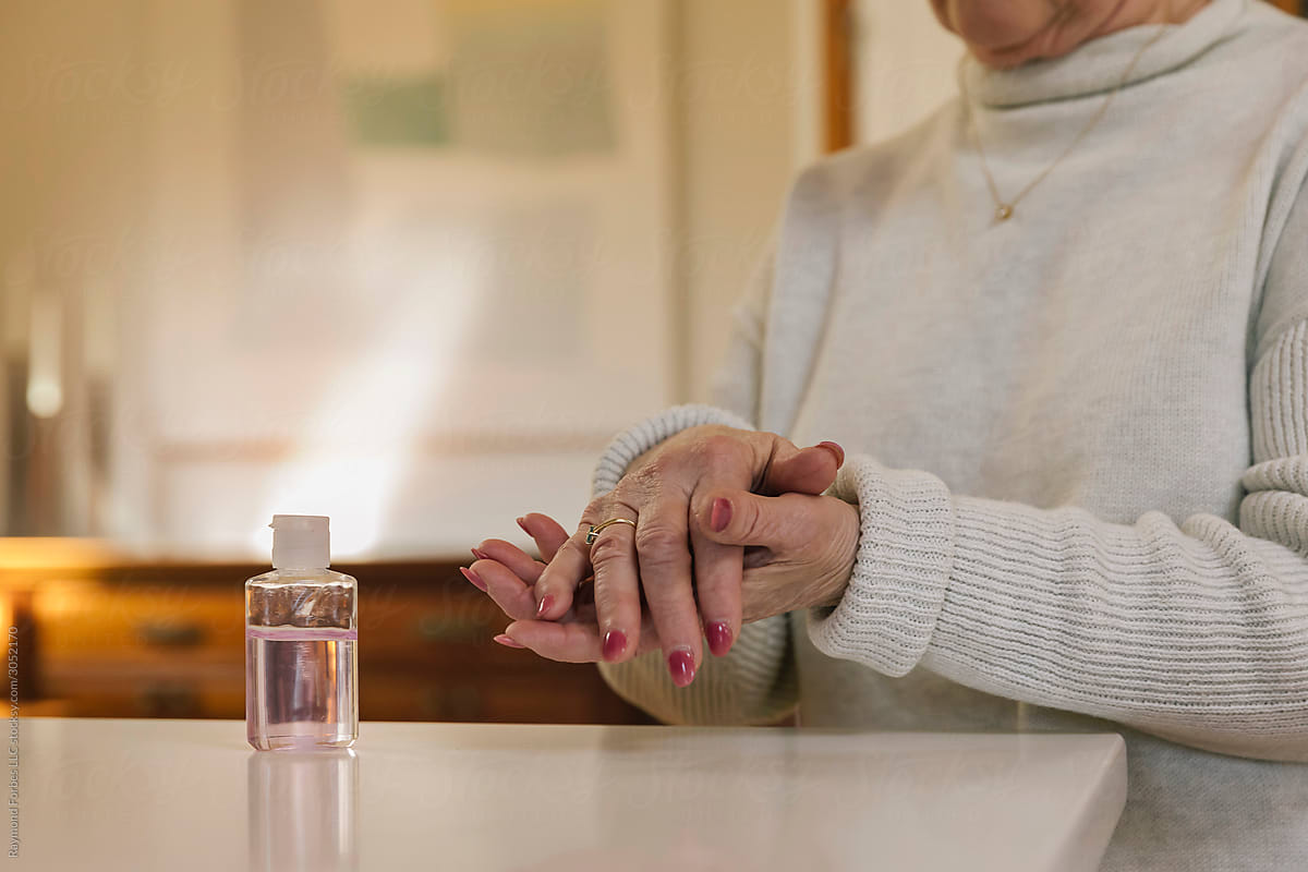Senior Citizen Putting Applying Hand Sanitizer