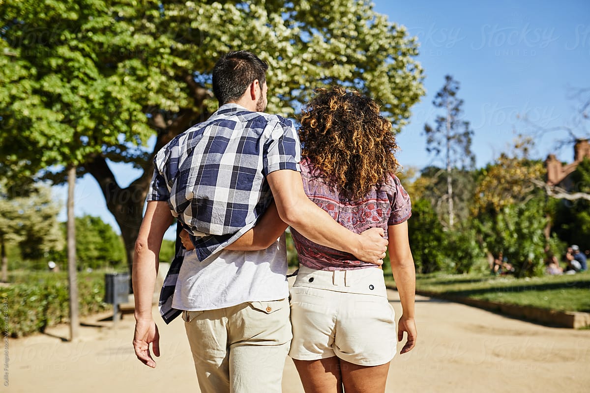 Embraced Couple Walking In Sunny Park By Stocksy Contributor Guille Faingold Stocksy