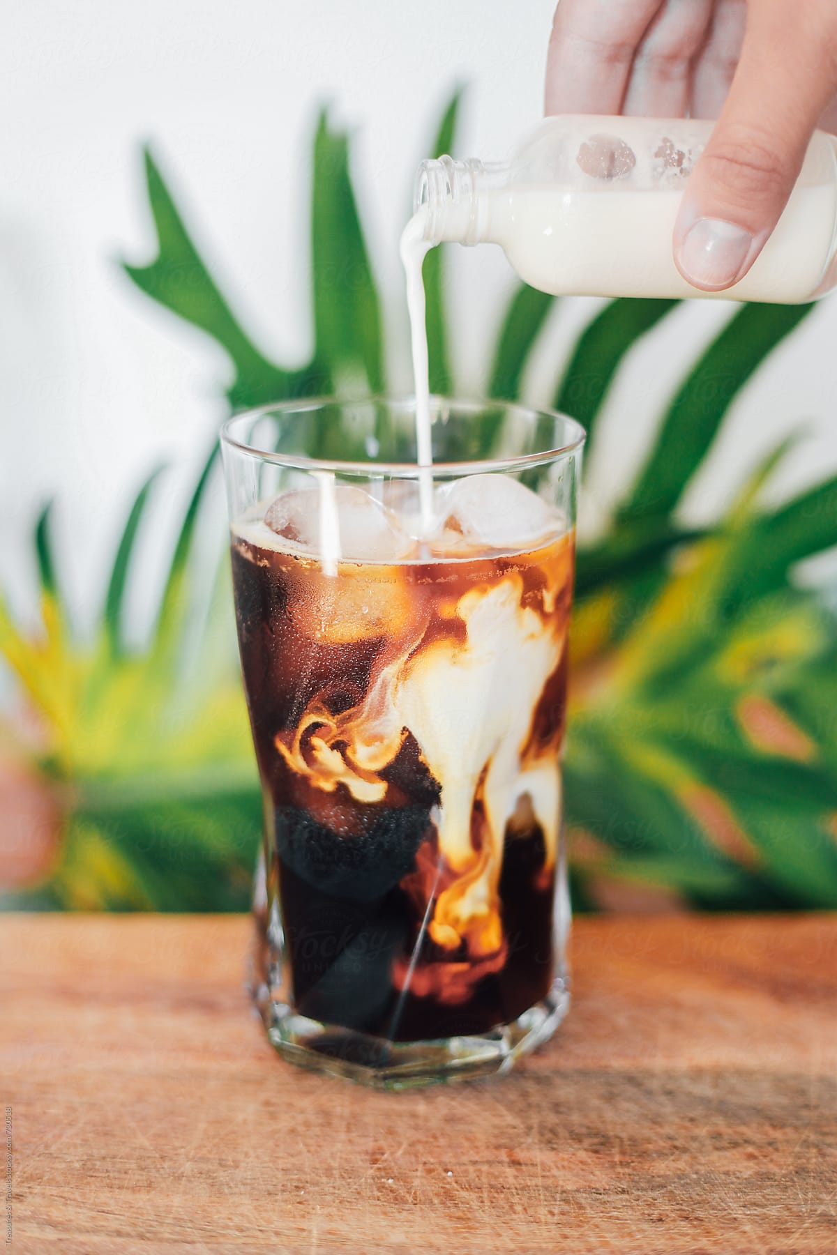 Pouring Milk Into An Iced Coffee By Stocksy Contributor Pink House