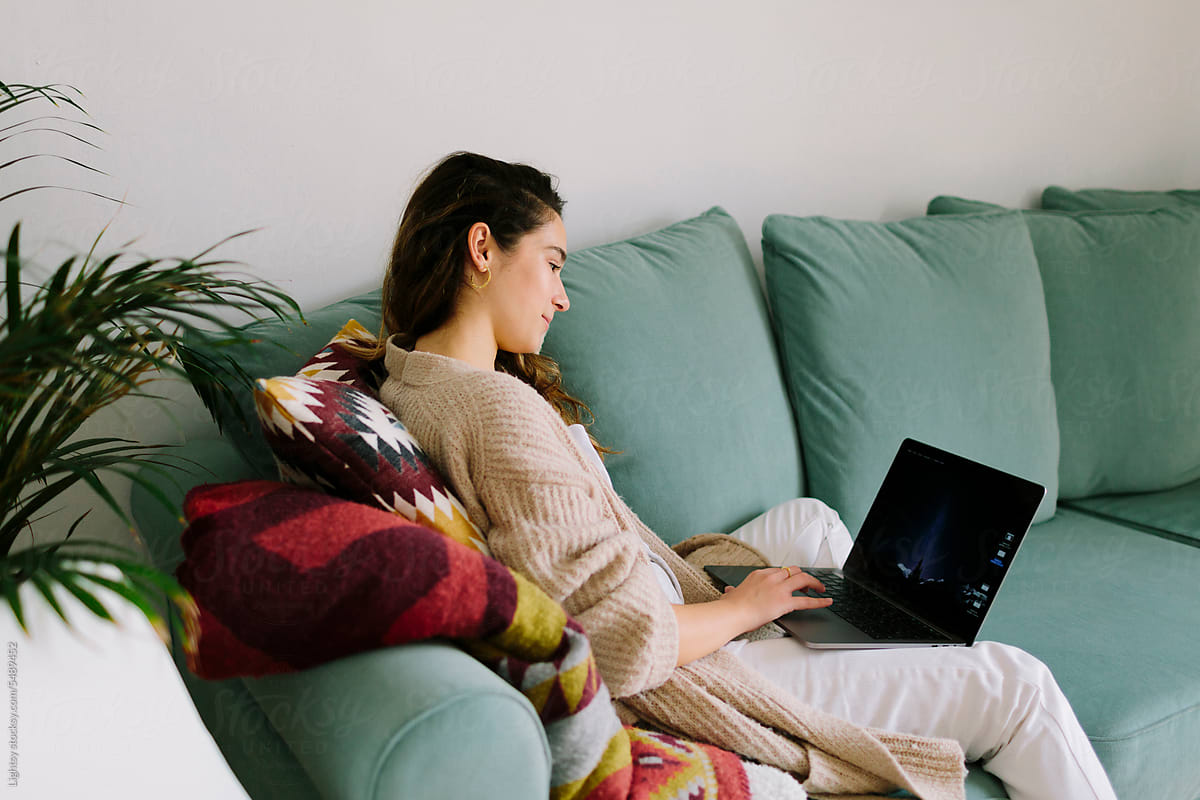 A woman using a laptop for work at home